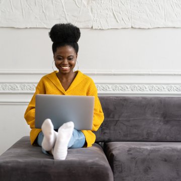 woman on sofa using voip